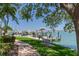 Scenic waterfront view featuring a well-maintained dock, lush landscaping, and calm waters with boats at 425 150Th Ave # 2301, Madeira Beach, FL 33708