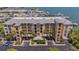 Beautiful waterfront condo building featuring a metal roof, tropical landscaping, and convenient parking at 425 150Th Ave # 2301, Madeira Beach, FL 33708