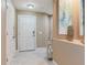 Welcoming foyer featuring neutral tones, tile flooring, and a secure front door with digital lock at 425 150Th Ave # 2301, Madeira Beach, FL 33708