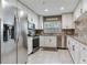 Modern kitchen featuring white cabinets, granite countertops, and stainless steel appliances at 425 150Th Ave # 2301, Madeira Beach, FL 33708