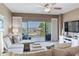 Bright living room with serene water views from the balcony and comfortable, stylish furnishings at 425 150Th Ave # 2301, Madeira Beach, FL 33708