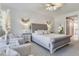 Spacious bedroom featuring a ceiling fan, sitting area, nightstands and ensuite bath at 425 150Th Ave # 2301, Madeira Beach, FL 33708