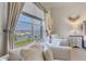 Sitting area offering stunning marina views through a large window with elegant drapery at 425 150Th Ave # 2301, Madeira Beach, FL 33708