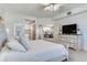 Spacious bedroom featuring a ceiling fan, sitting area, large dresser, and ensuite bath at 425 150Th Ave # 2301, Madeira Beach, FL 33708
