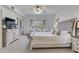 This spacious bedroom boasts an upholstered headboard, ceiling fan and sitting area by the window at 425 150Th Ave # 2301, Madeira Beach, FL 33708