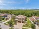 An aerial view showing the beautiful home with a three-car garage, a paver driveway, and mature landscaping at 4419 Ortona Ln, Wesley Chapel, FL 33543