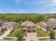 Aerial view of the house with well-maintained landscaping and a paver driveway, in a suburban neighborhood at 4419 Ortona Ln, Wesley Chapel, FL 33543