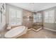 Luxurious bathroom with soaking tub, tiled shower, and window with plantation shutters at 4419 Ortona Ln, Wesley Chapel, FL 33543