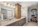 Bathroom featuring dual vanities, granite countertops, and soaking tub at 4419 Ortona Ln, Wesley Chapel, FL 33543