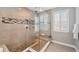 This bathroom features a glass enclosed shower with stone floor and a built-in bench at 4419 Ortona Ln, Wesley Chapel, FL 33543