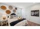 Cozy bedroom with a decorated wall, comfortable bed with decorative pillows, and bright natural light at 4419 Ortona Ln, Wesley Chapel, FL 33543