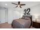 Comfortable bedroom featuring a ceiling fan, carpeted floors, and a queen-size bed with throw blanket at 4419 Ortona Ln, Wesley Chapel, FL 33543
