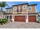 Charming two-story home featuring a brick-paved driveway, a three-car garage, and a well-manicured front lawn at 4419 Ortona Ln, Wesley Chapel, FL 33543