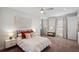 Light and bright main bedroom features ensuite bath, sitting area, and modern decor at 4419 Ortona Ln, Wesley Chapel, FL 33543