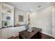 Comfortable home office with custom shelving, decorative items, and a tufted chair at 4419 Ortona Ln, Wesley Chapel, FL 33543