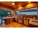 Outdoor kitchen with stainless steel grill, stone countertops, and bar seating, perfect for entertaining at 4419 Ortona Ln, Wesley Chapel, FL 33543