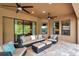 Covered patio featuring comfortable seating, ceiling fans, and tile flooring for relaxing outdoor gatherings at 4419 Ortona Ln, Wesley Chapel, FL 33543