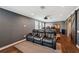 Home theater featuring reclining chairs, a projector, wood floors, and a refreshment bar at 4419 Ortona Ln, Wesley Chapel, FL 33543