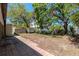Large backyard with a storage shed and a brick-paved walkway, ideal for outdoor activities at 4425 W Bay Villa Ave, Tampa, FL 33611