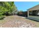 Spacious backyard with a screened-in patio, lush greenery, and a privacy fence at 4425 W Bay Villa Ave, Tampa, FL 33611