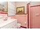 Bathroom features pink tile, a vanity, and a shower with a glass door at 4425 W Bay Villa Ave, Tampa, FL 33611