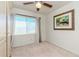 Bedroom with neutral carpet, ceiling fan, and natural light from the window at 4425 W Bay Villa Ave, Tampa, FL 33611