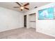 Bedroom featuring neutral carpet, a closet, and a decorative ceiling fan at 4425 W Bay Villa Ave, Tampa, FL 33611