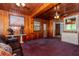 Living room with wood paneled walls, purple carpet, and artful decor at 4425 W Bay Villa Ave, Tampa, FL 33611