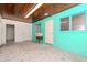 Versatile room with unique painted floors, turquoise walls, and a wood-paneled ceiling at 4425 W Bay Villa Ave, Tampa, FL 33611
