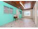 Room featuring custom painted floor, turquoise walls, and views of the yard at 4425 W Bay Villa Ave, Tampa, FL 33611