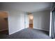 Bedroom featuring carpet, closet, and sliding glass door for natural light at 455 Alt 19 S # 235, Palm Harbor, FL 34683