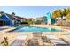 Sparkling community pool with lounge chairs and lush landscaping at 455 Alt 19 S # 235, Palm Harbor, FL 34683