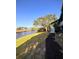 Waterfront condo featuring a grassy lawn, mature trees and a private walkway at 455 Alt 19 S # 235, Palm Harbor, FL 34683