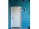 Charming front door with bright blue siding and white trim at 455 Alt 19 S # 235, Palm Harbor, FL 34683