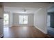 Open-concept living room with wood floors and sliding doors to the outside at 455 Alt 19 S # 235, Palm Harbor, FL 34683