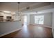 Open living area with wood floors, a ceiling fan, and easy kitchen access at 455 Alt 19 S # 235, Palm Harbor, FL 34683