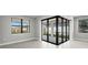 Bright living area with large windows offering backyard views and sliding glass door at 4576 Blue Star Ct, North Port, FL 34289