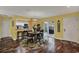 The dining area features wood floors, a round table, and access to the outside patio at 50 Balsam Dr, Oldsmar, FL 34677