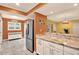 The kitchen features granite countertops, white cabinetry, and stainless steel appliances at 50 Balsam Dr, Oldsmar, FL 34677