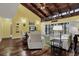 Cozy living room showcasing vaulted wood ceilings, hardwood floors, and sliding glass doors to the patio at 50 Balsam Dr, Oldsmar, FL 34677