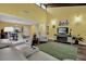 Open living area features wood floors, vaulted ceilings, modern furnishings, and a green area rug at 50 Balsam Dr, Oldsmar, FL 34677
