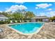 Community pool area with plenty of lounge chairs for relaxing under the sun at 50 Balsam Dr, Oldsmar, FL 34677