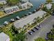 Aerial view of waterfront condos, boat docks, canal, and parking lot with vehicles at 5174 Beach Se Dr # B, St Petersburg, FL 33705
