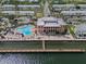 Stunning aerial view of waterfront property with a pool, dock, and lush landscaping at 5174 Beach Se Dr # B, St Petersburg, FL 33705