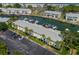 Scenic aerial view of waterfront condos with boat docks, canal, and parking lot with vehicles at 5174 Beach Se Dr # B, St Petersburg, FL 33705