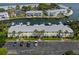 Scenic aerial view of waterfront condos with boat docks, canal, and parking lot with vehicles at 5174 Beach Se Dr # B, St Petersburg, FL 33705