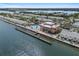 Beautiful aerial view showcasing waterfront condos, a pool, and a long fishing pier at 5174 Beach Se Dr # B, St Petersburg, FL 33705