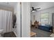 A combined view of a bathroom featuring a shower/tub combo and adjacent living area with a seating bench at 5174 Beach Se Dr # B, St Petersburg, FL 33705