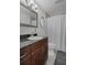 The bathroom showcases a vanity with a dark countertop and a shower with neutral-toned tile and a shower curtain at 5174 Beach Se Dr # B, St Petersburg, FL 33705