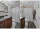 The bathroom features a vanity with dark countertop and a shower with a neutral-toned curtain at 5174 Beach Se Dr # B, St Petersburg, FL 33705